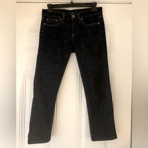 Dark blue cropped low rise skinny leg jeans.